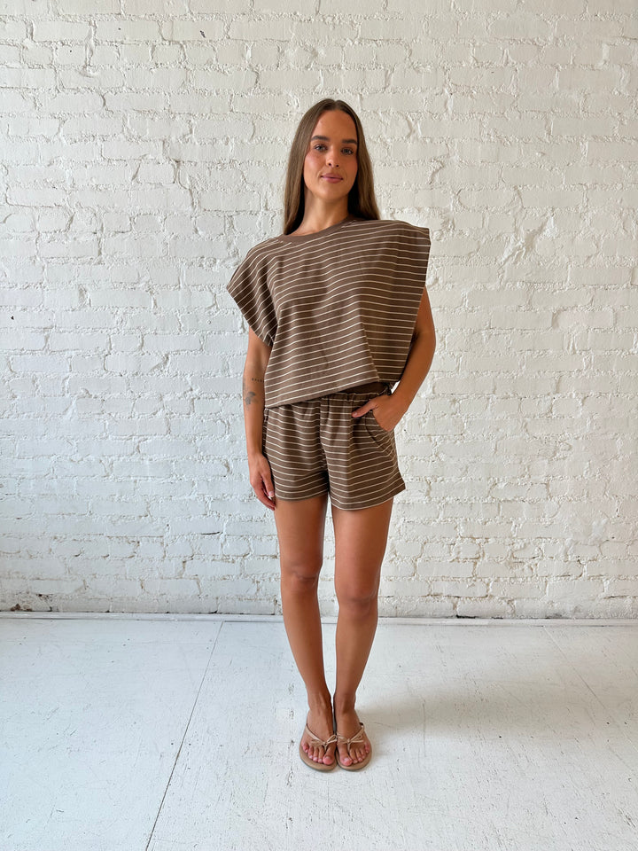 Woman wearing brown and tan striped two piece short lounge set. 