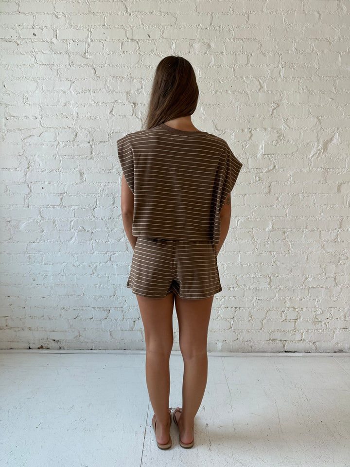 Woman wearing brown and tan striped two piece short lounge set. 