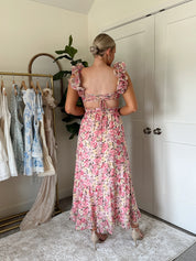 Pink and yellow floral midi dress with ruffle straps, side cutouts, and open lace-up back