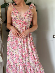 Pink and yellow floral midi dress with ruffle straps, side cutouts, and open lace-up back