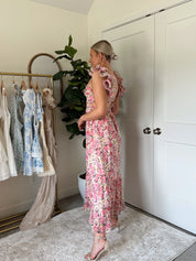 Pink and yellow floral midi dress with ruffle straps, side cutouts, and open lace-up back