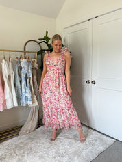 Pink and yellow floral midi dress with ruffle straps, side cutouts, and open lace-up back