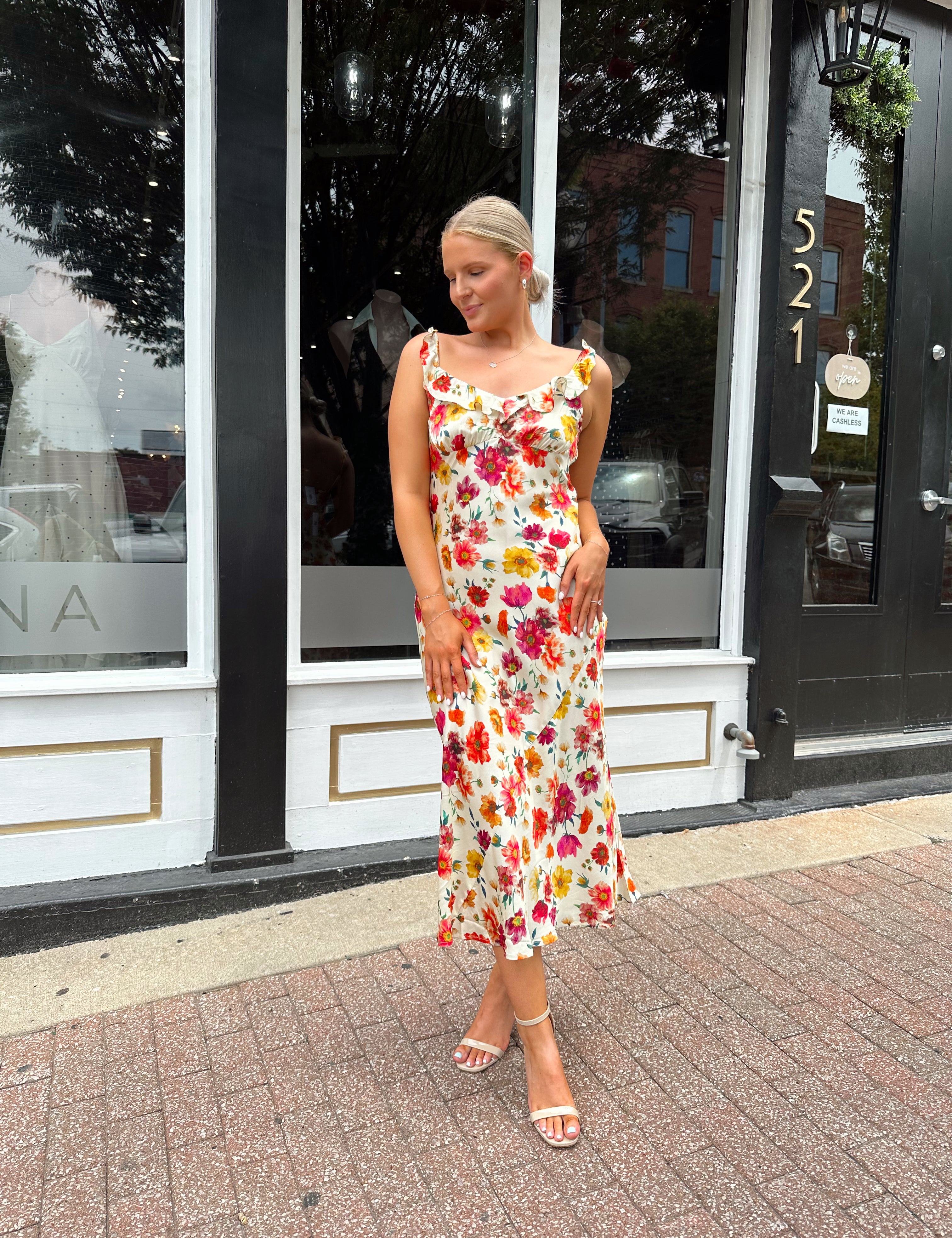 Multicolor floral pattern satin midi dress with ruffle trim detail.