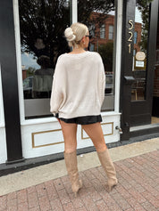 Long sleeve ivory waffle knit sweater with over sized fit. 