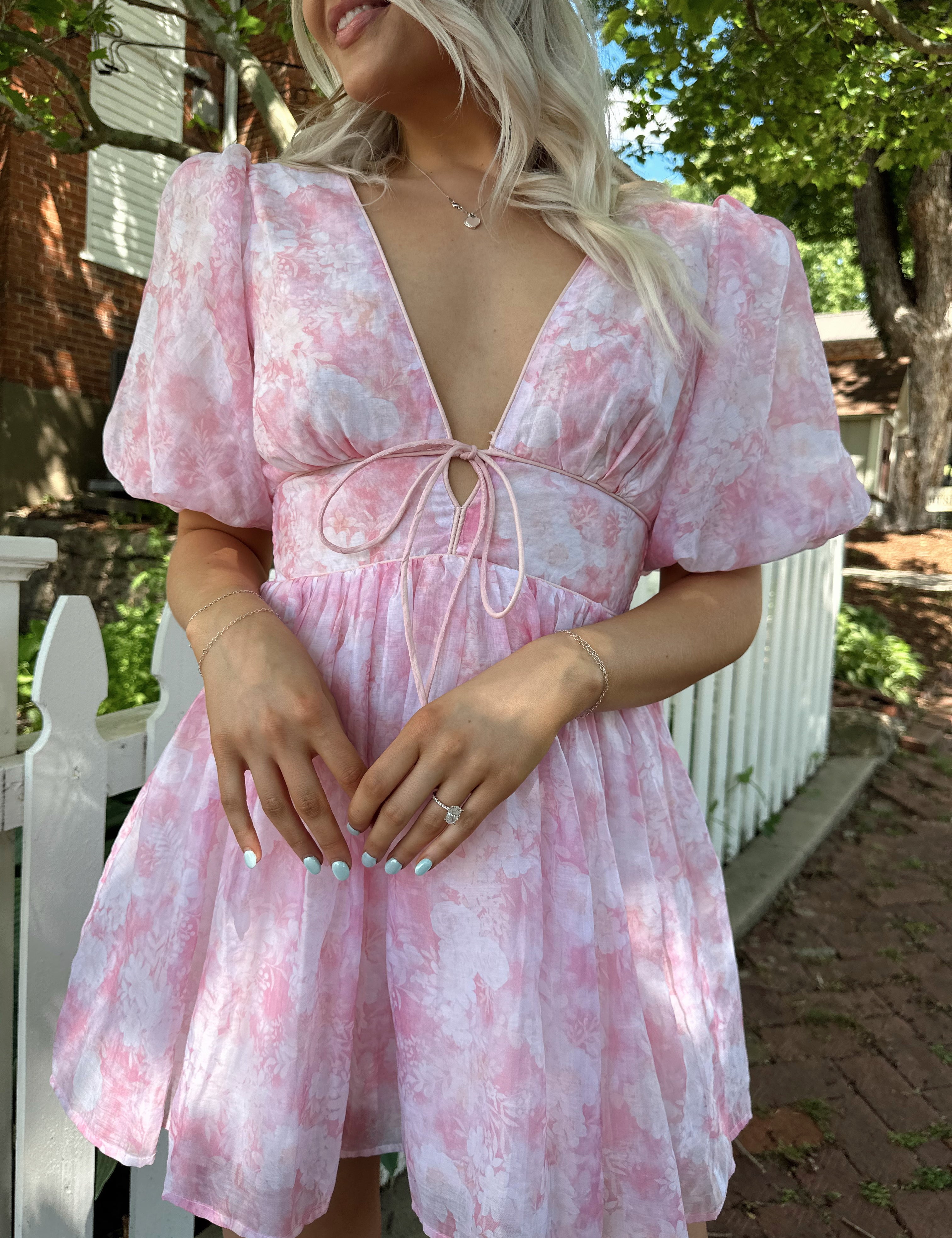 Light pink mini dress with floral pattern and puff sleeves.