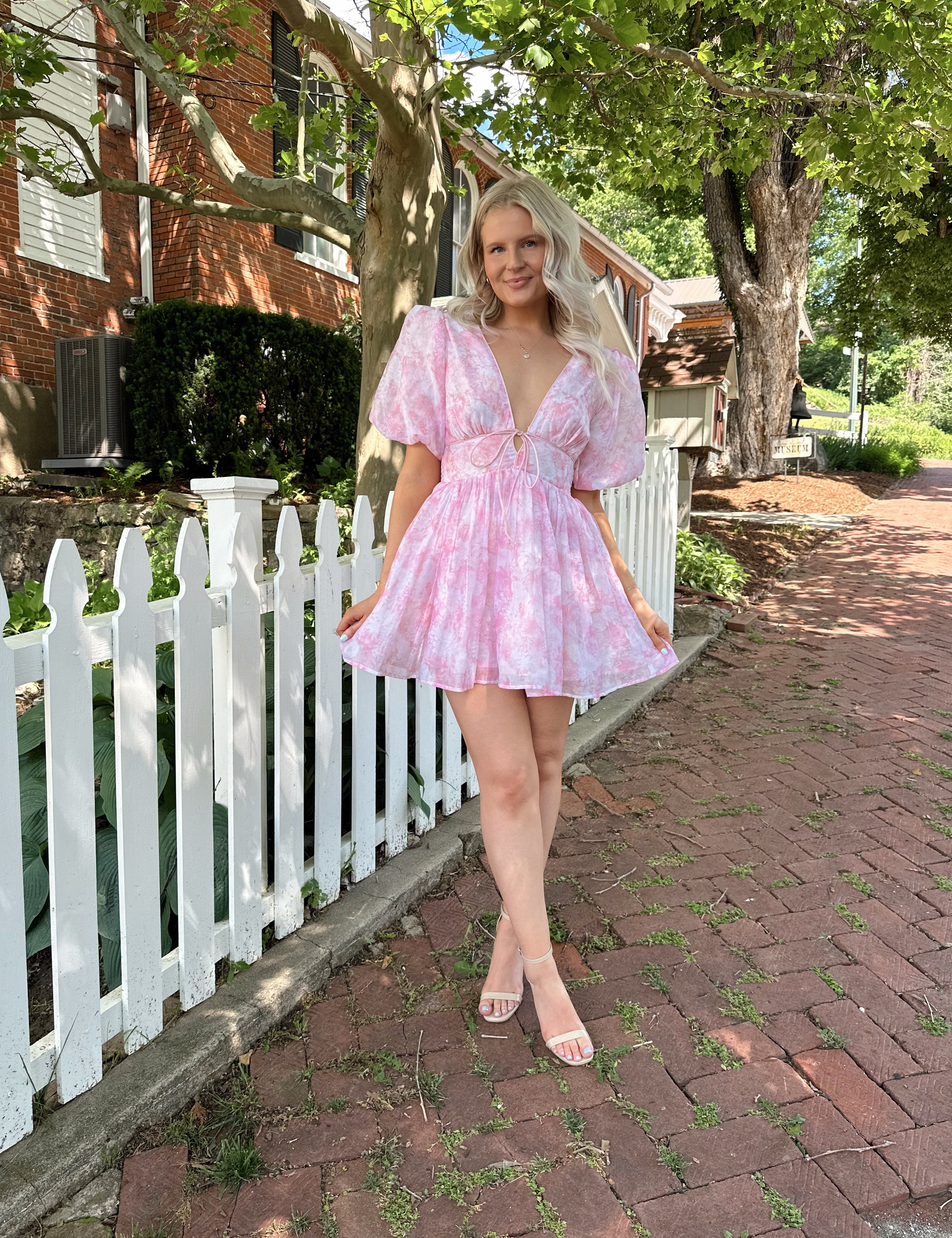 Light pink mini dress with floral pattern and puff sleeves.