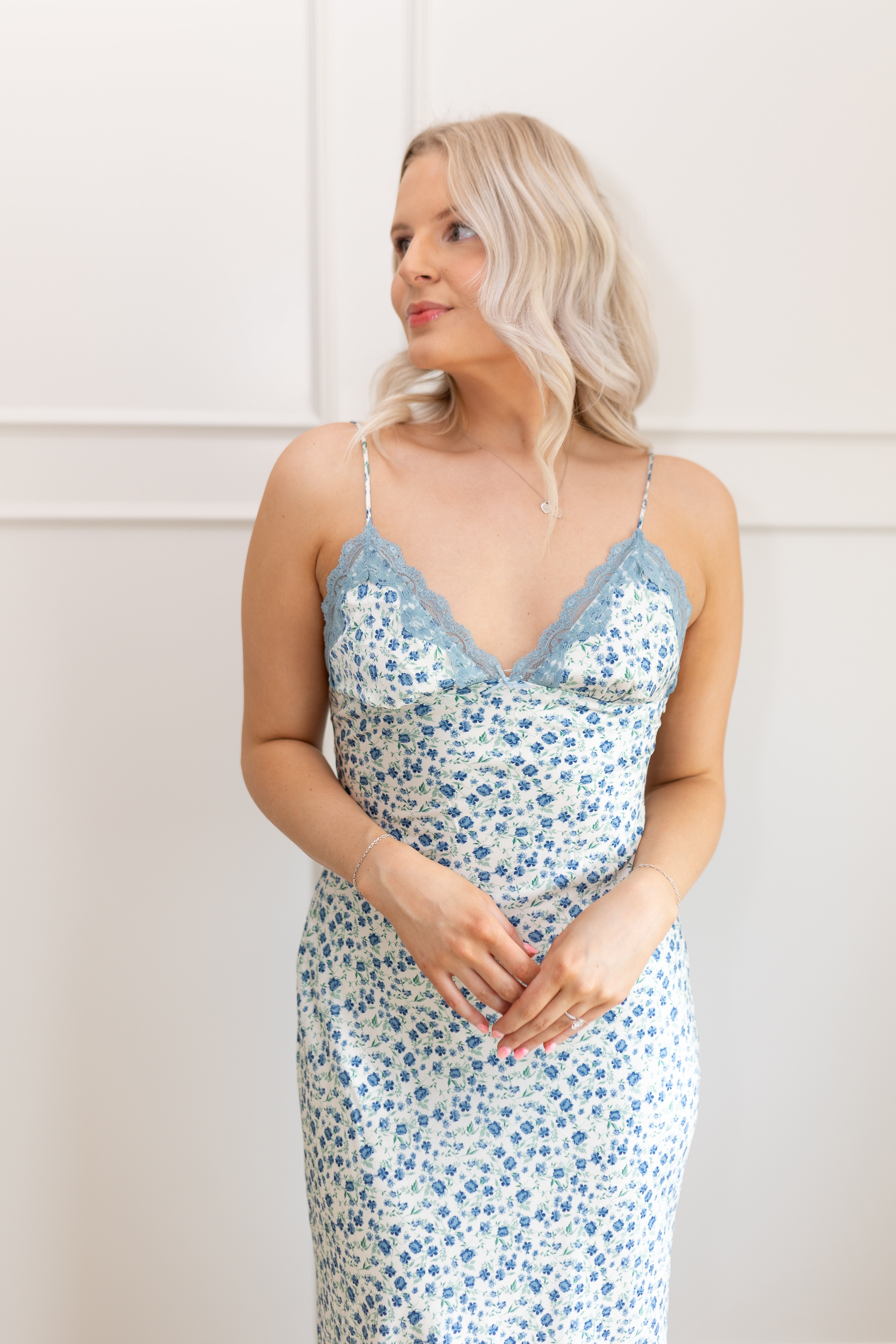 Blue floral satin midi dress with lace trim. Adjustable spaghetti straps.