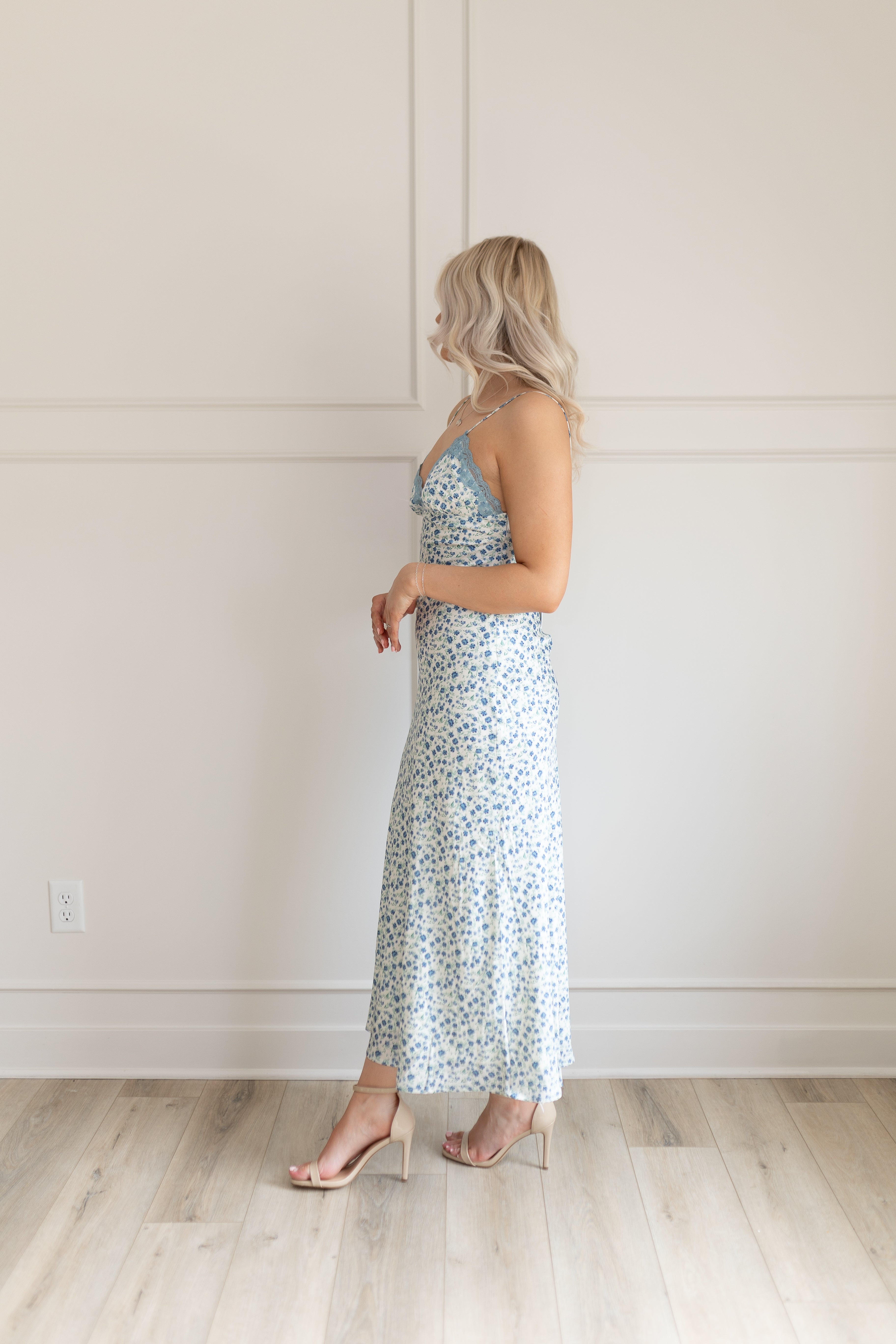 Blue floral satin midi dress with lace trim. Adjustable spaghetti straps.