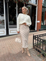 Cream colored chunky knit cardigan with tortuous shell buttons. 