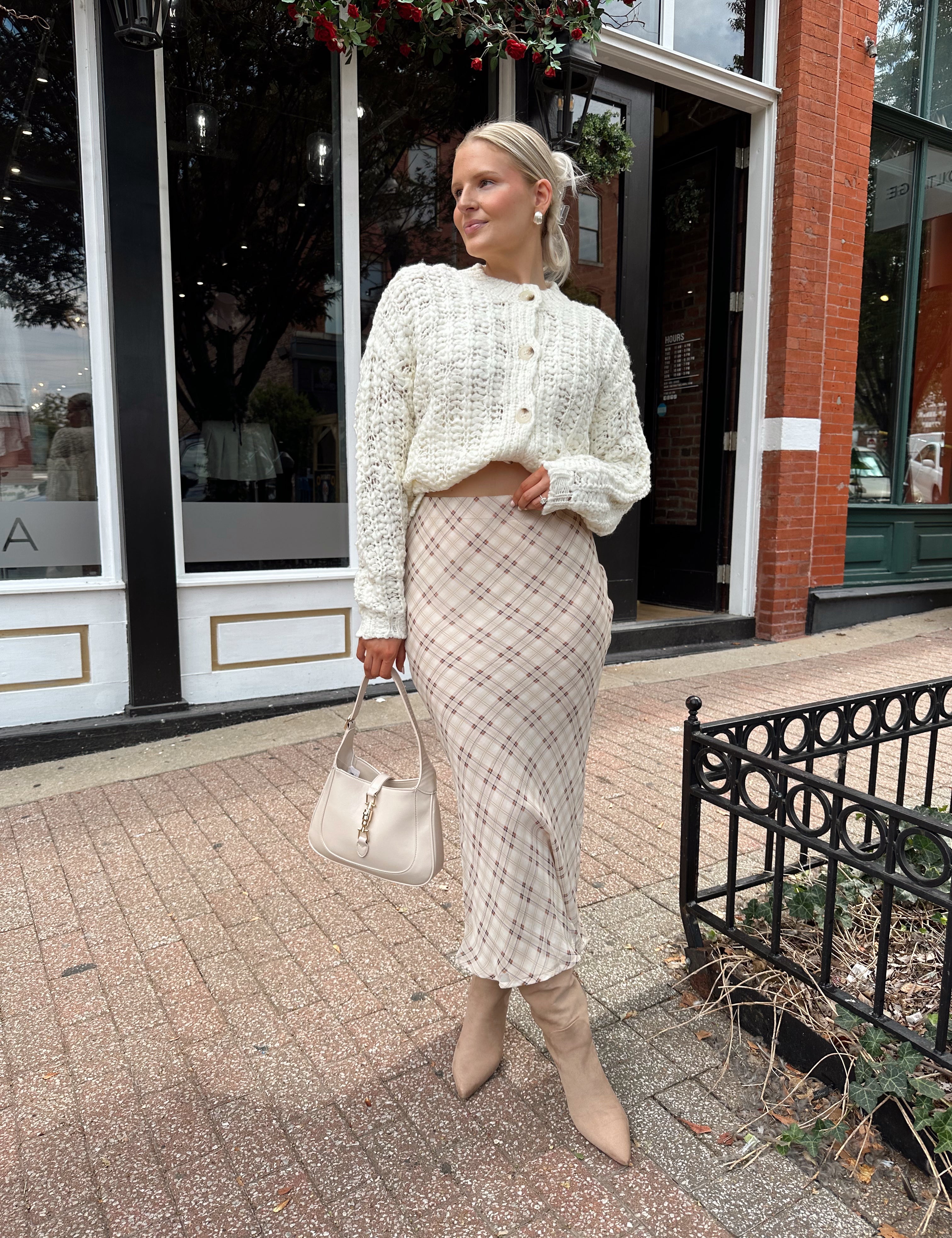 Cream colored chunky knit cardigan with tortuous shell buttons. 