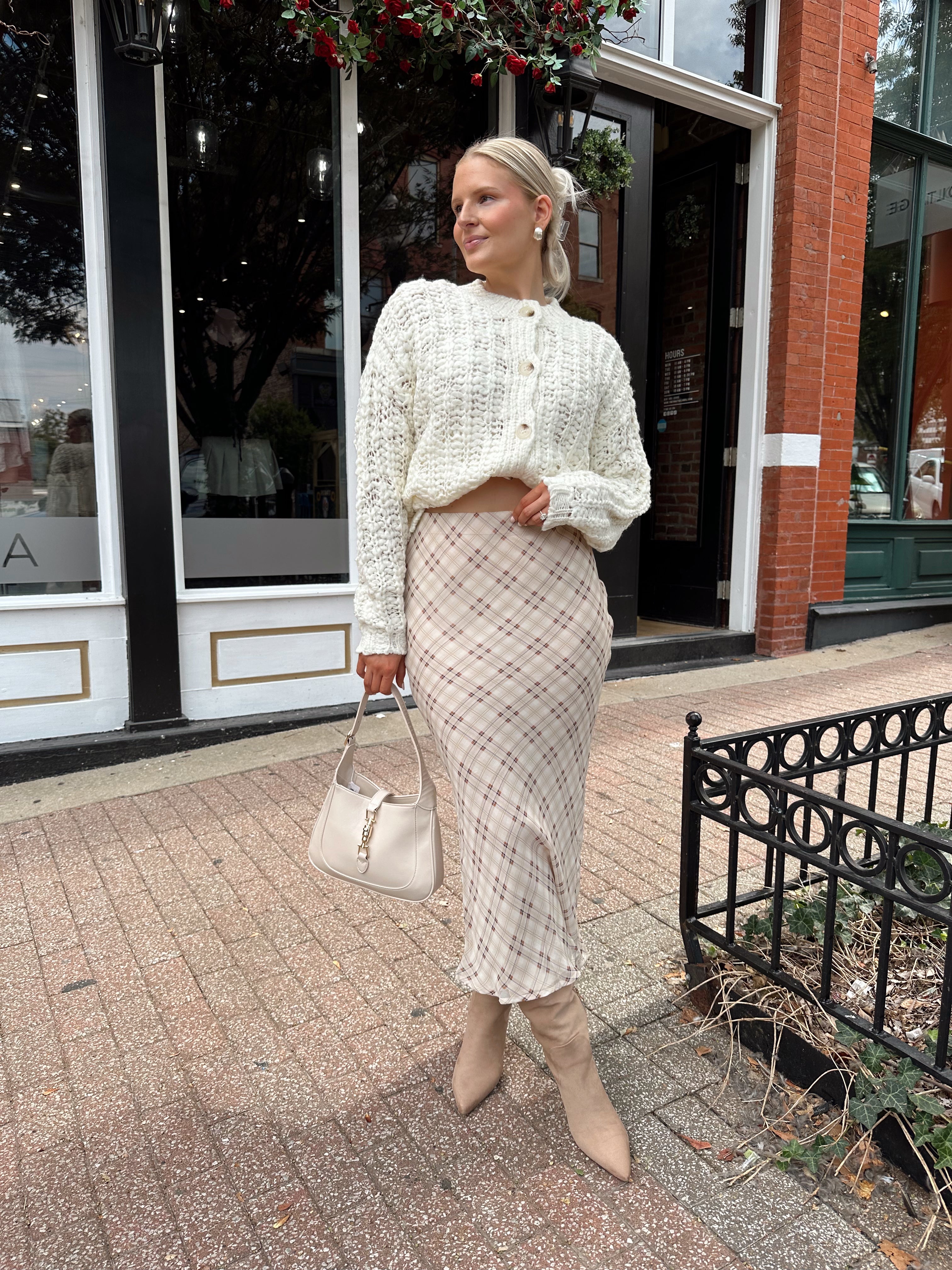Cream colored chunky knit cardigan with tortuous shell buttons. 