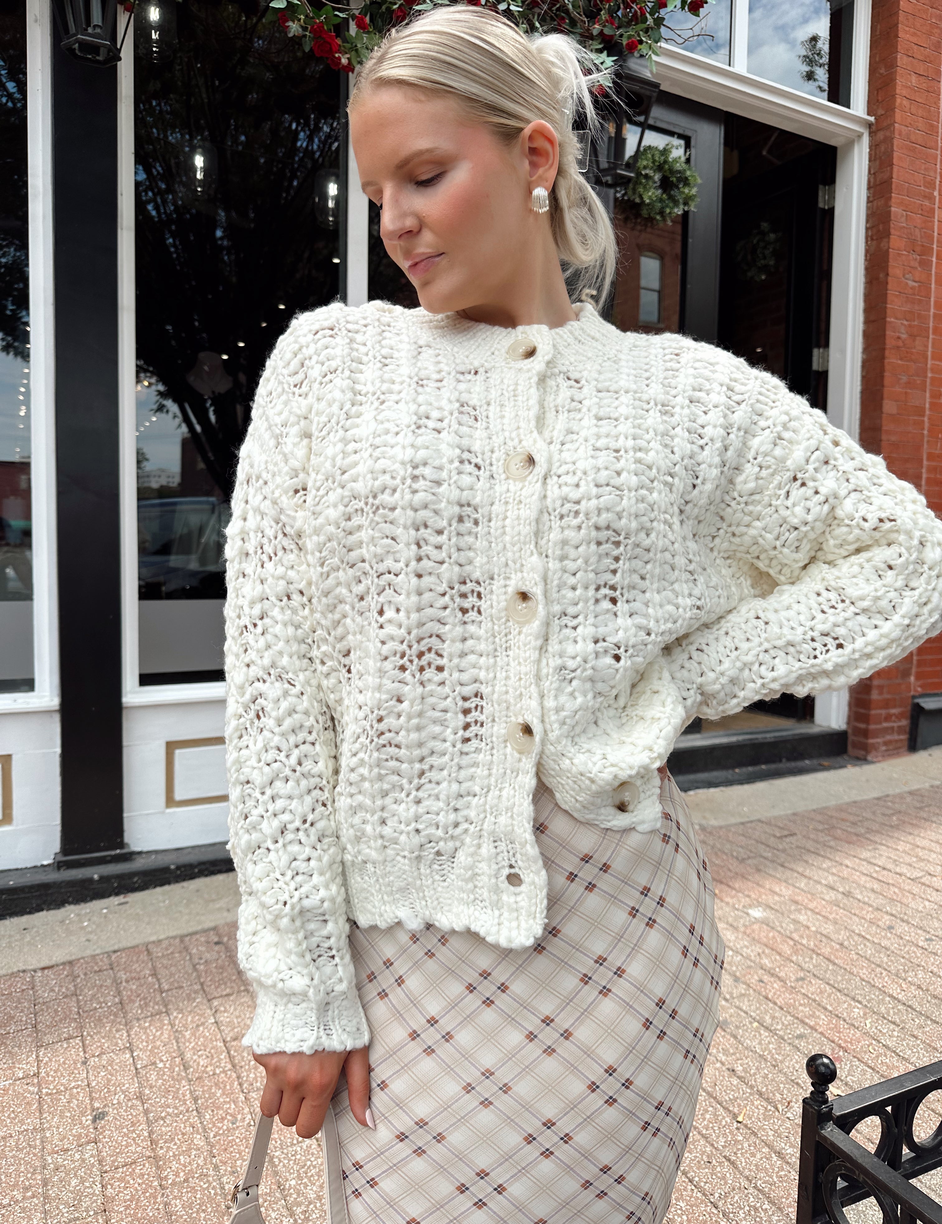 Cream colored chunky knit cardigan with tortuous shell buttons. 