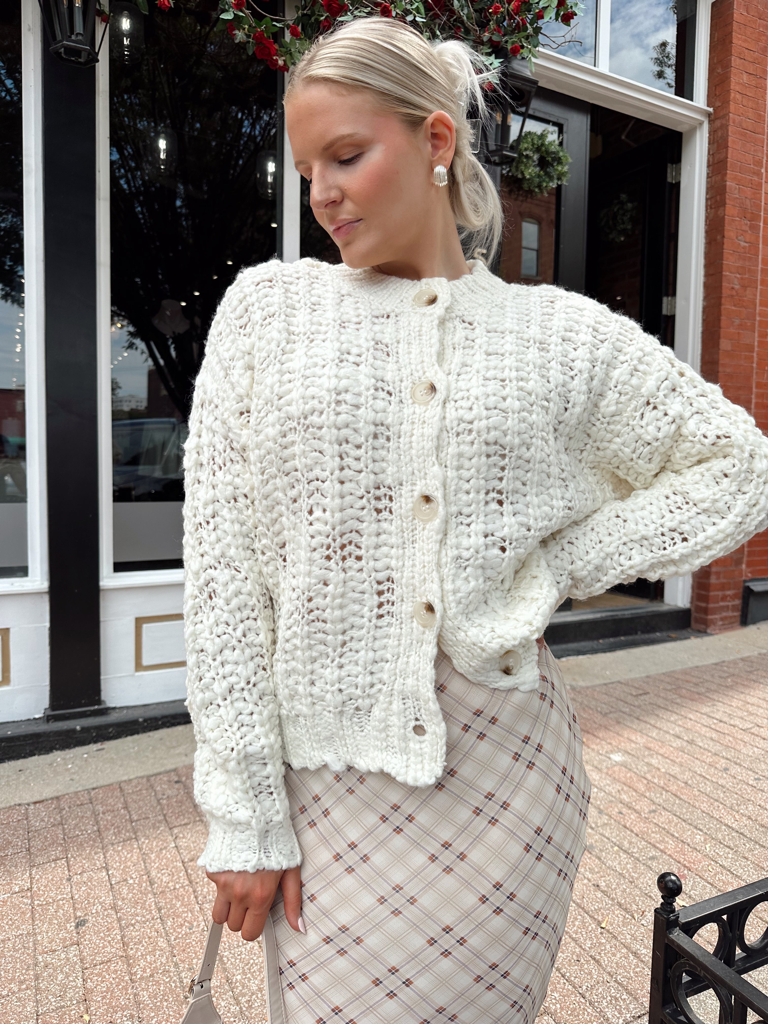 Cream colored chunky knit cardigan with tortuous shell buttons. 