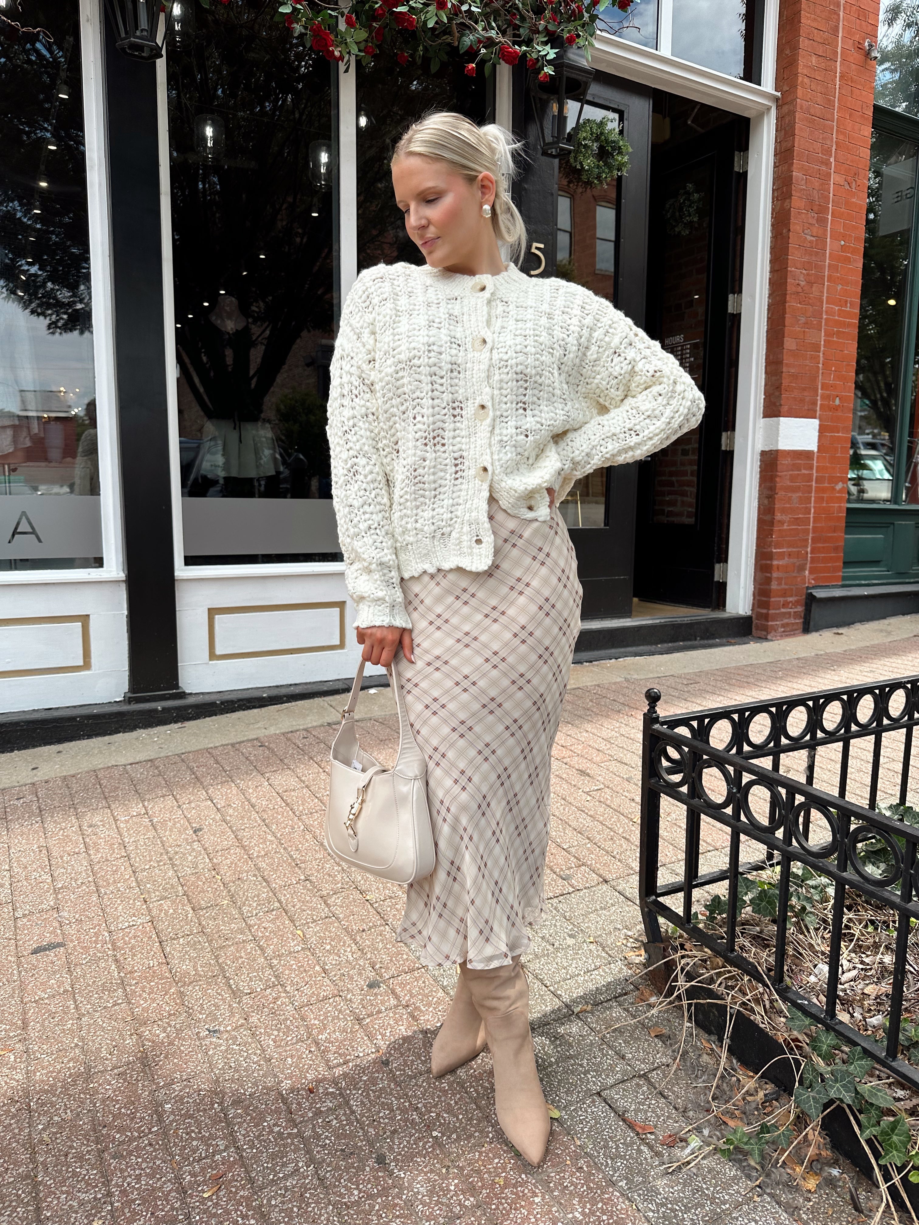Cream colored chunky knit cardigan with tortuous shell buttons. 