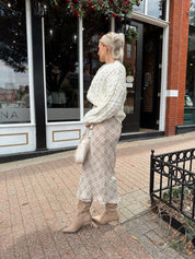 Cream colored chunky knit cardigan with tortuous shell buttons. 