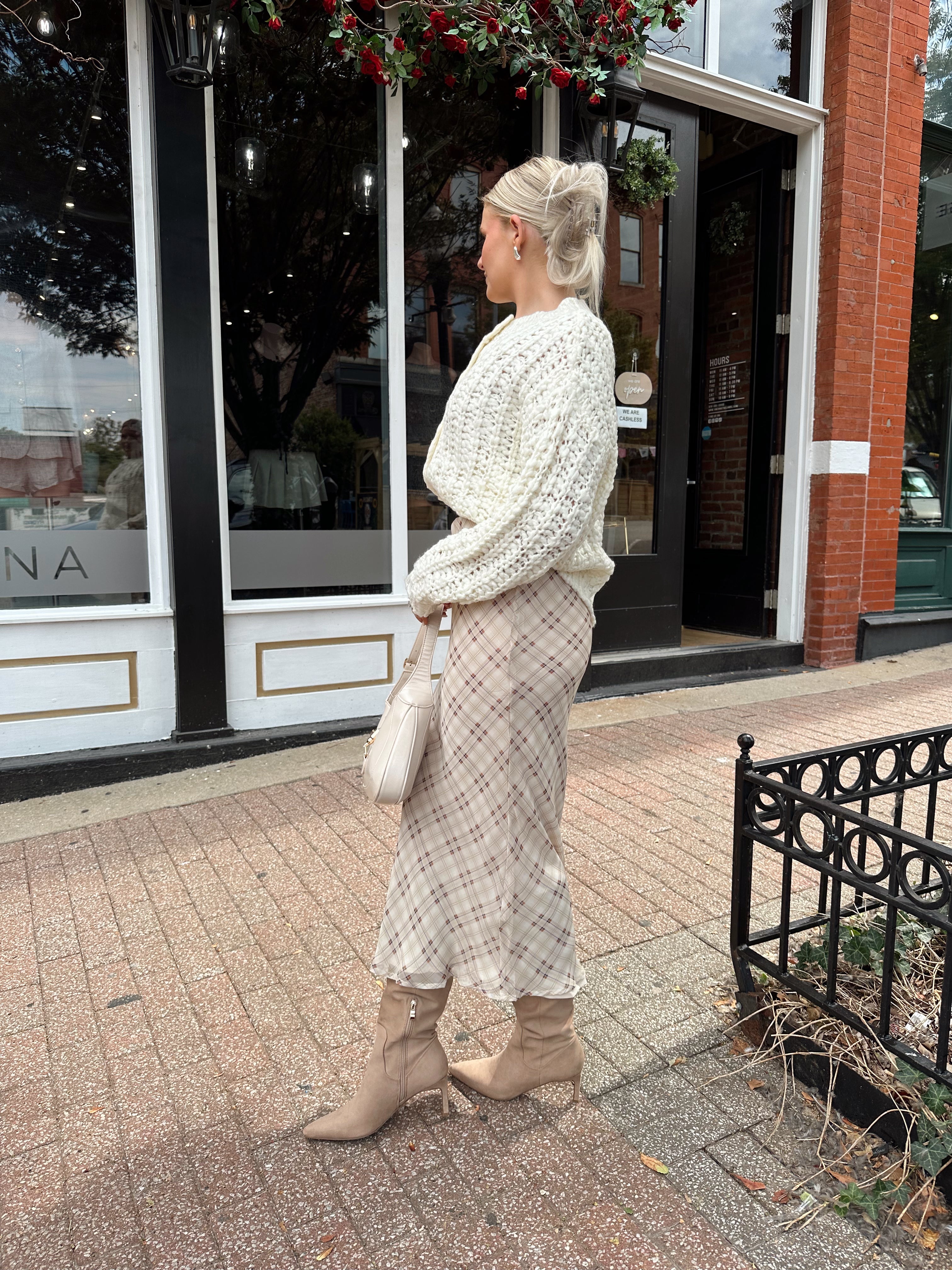 Cream colored chunky knit cardigan with tortuous shell buttons. 