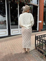 Cream colored chunky knit cardigan with tortuous shell buttons. 