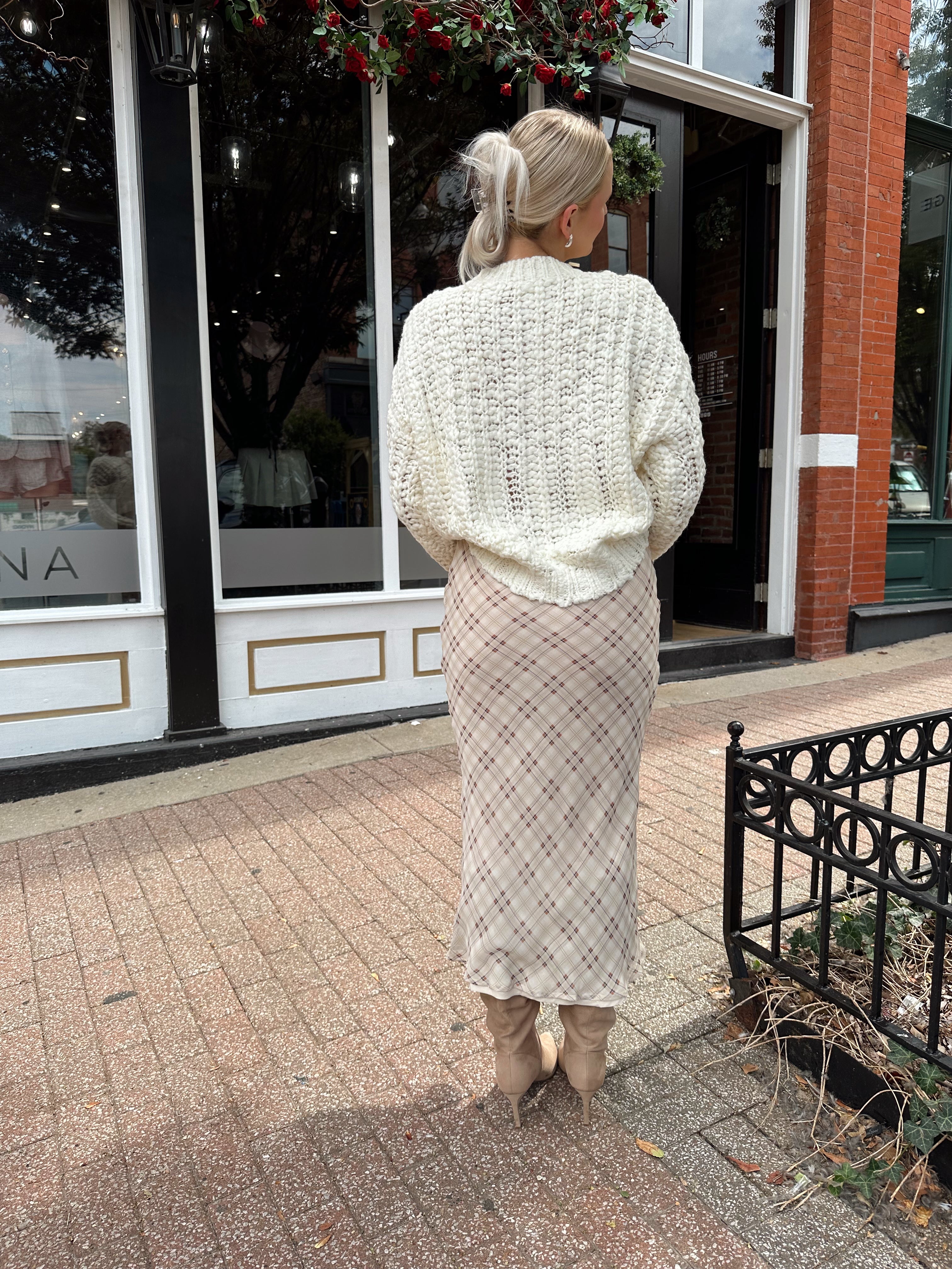 Cream colored chunky knit cardigan with tortuous shell buttons. 