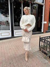 Cream colored chunky knit cardigan with tortuous shell buttons. 
