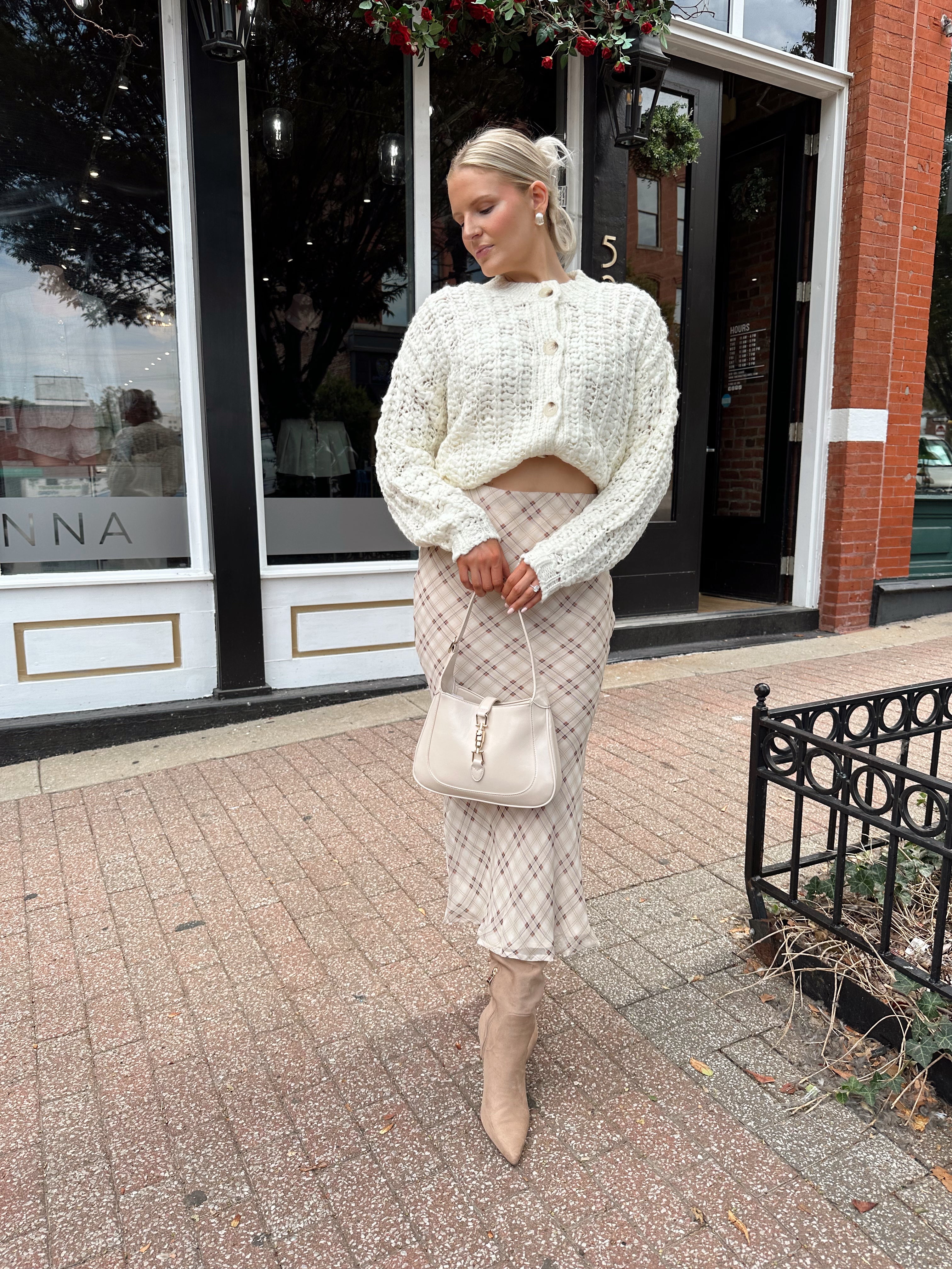 Cream colored chunky knit cardigan with tortuous shell buttons. 