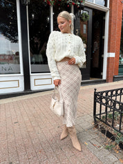 Cream colored chunky knit cardigan with tortuous shell buttons. 