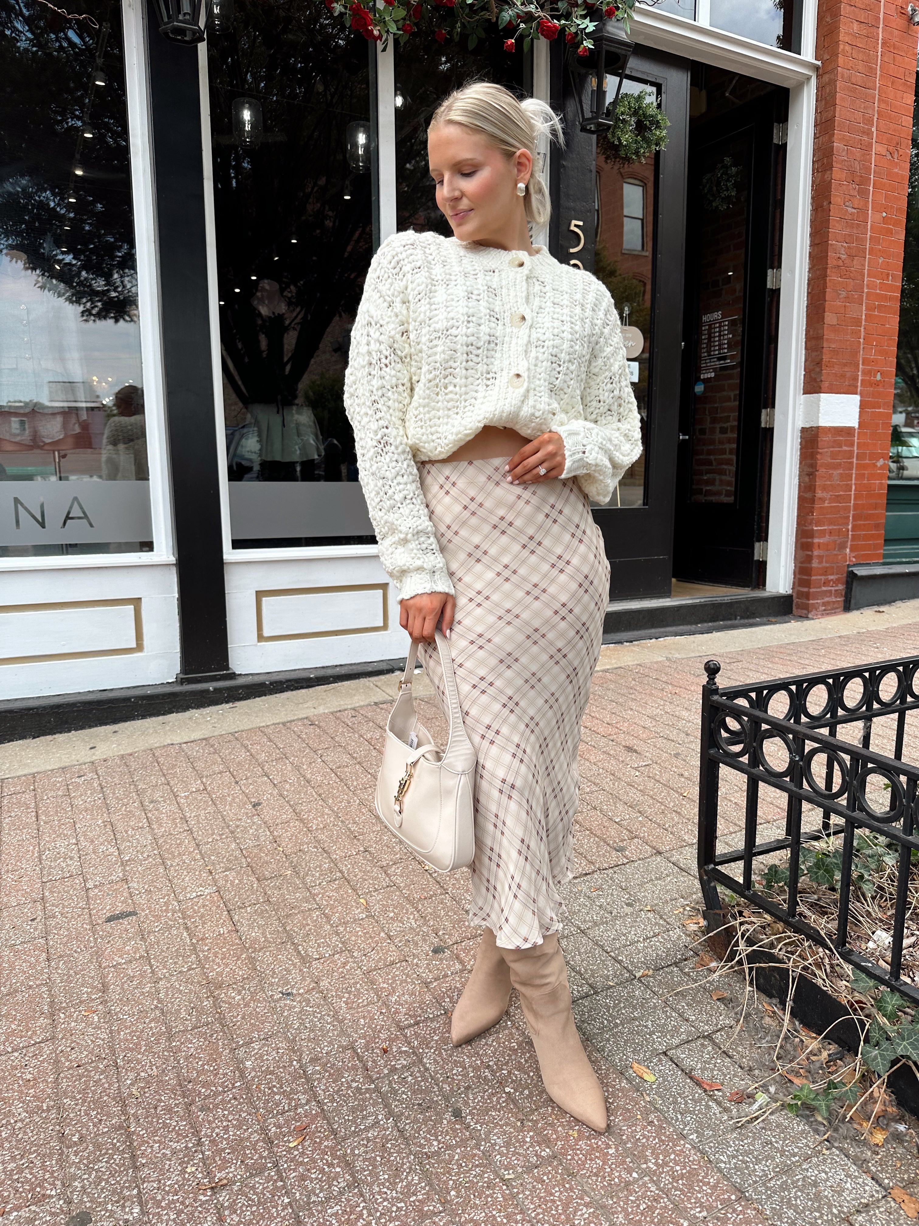 Cream colored chunky knit cardigan with tortuous shell buttons. 