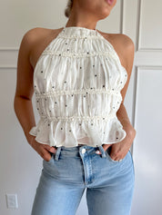 White polka dot tiered halter neck top with open back.