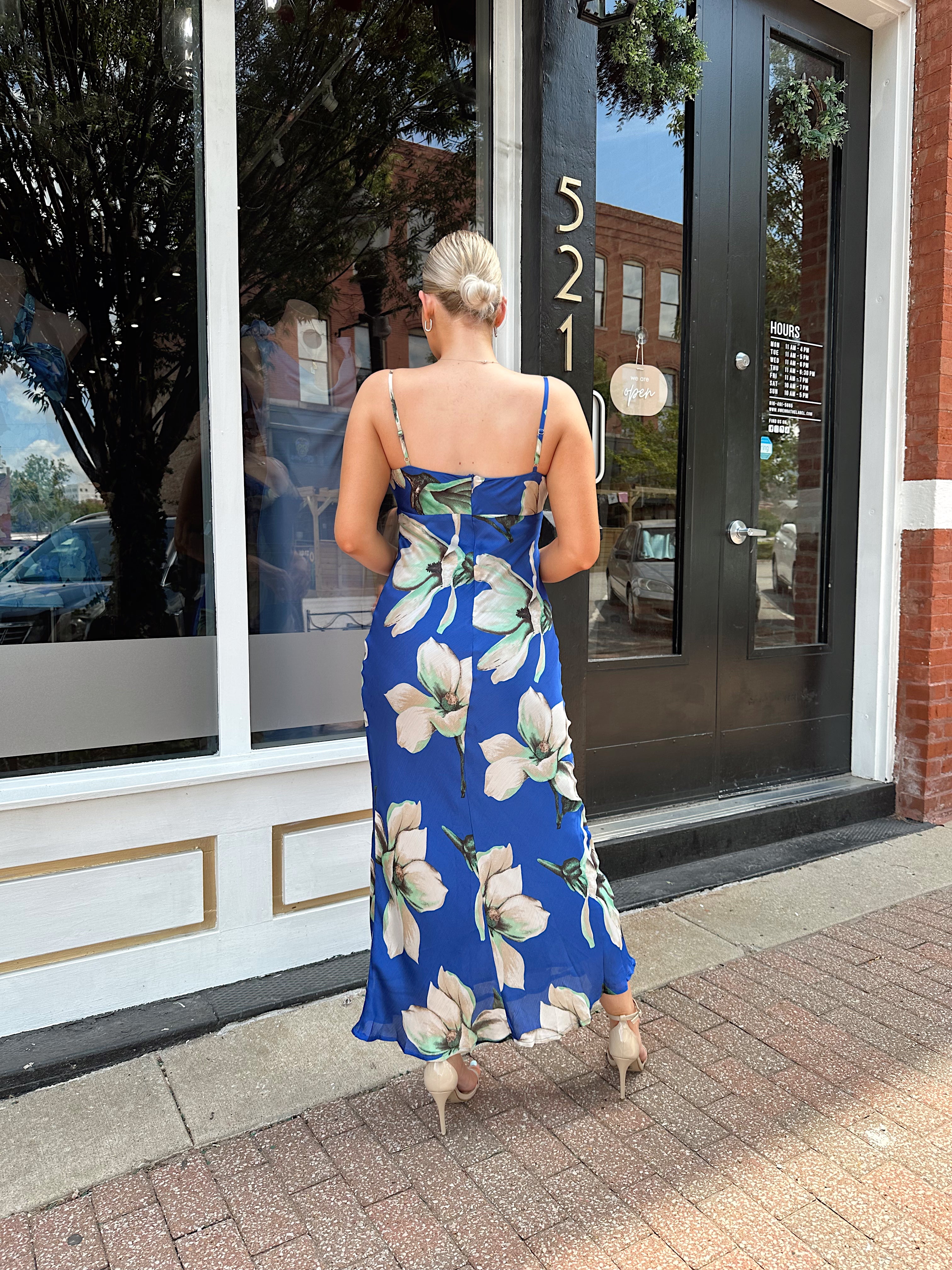 Royal blue satin midi dress with floral pattern.