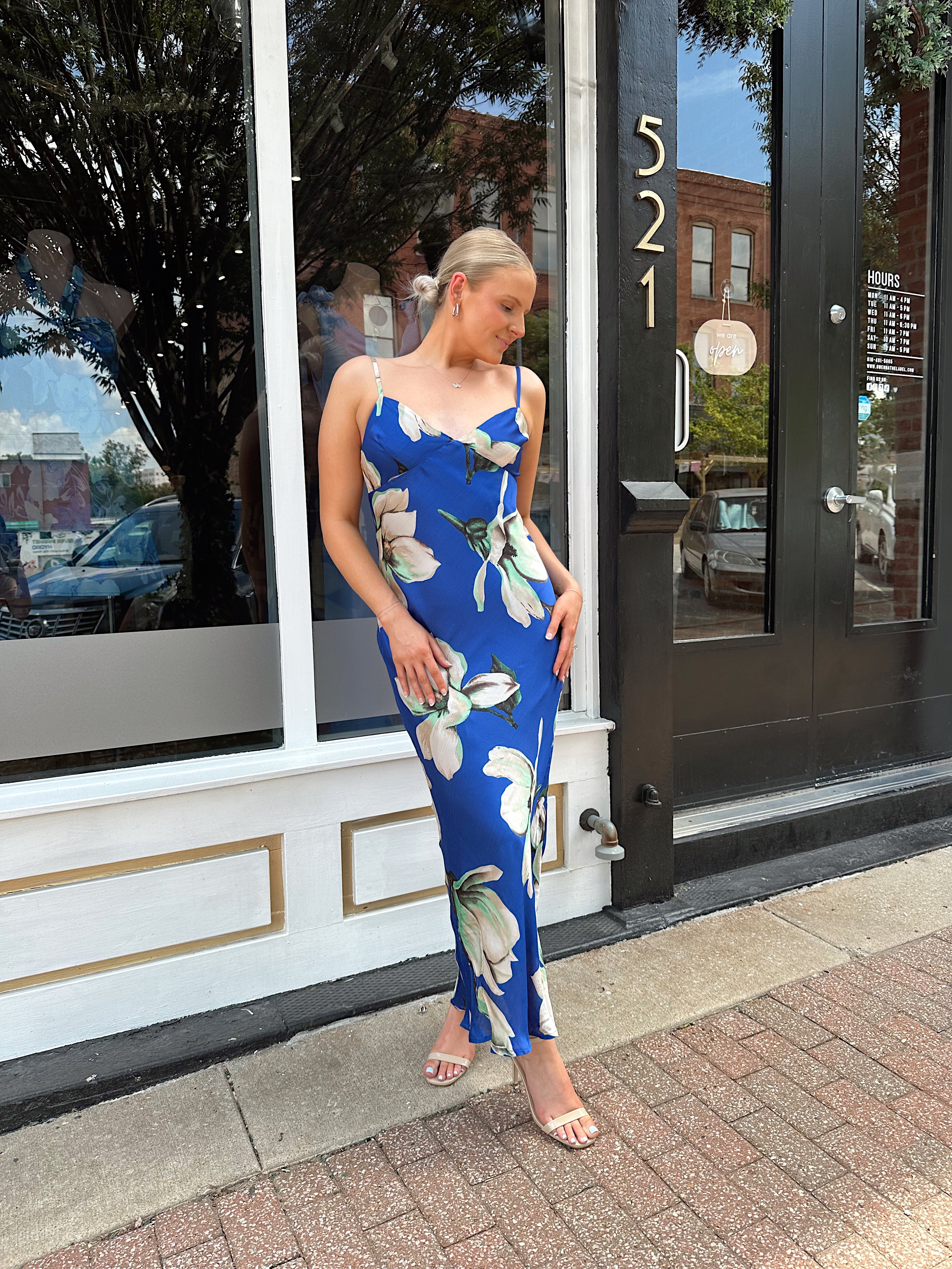Royal blue satin midi dress with floral pattern.