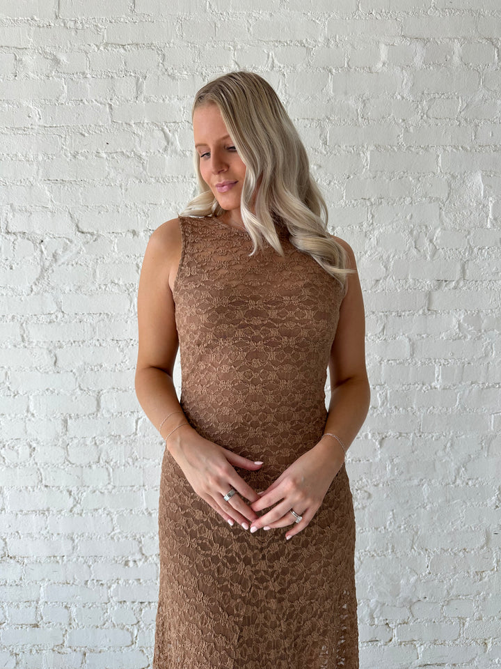 Woman wearing brown lace maxi dress with clear heels.