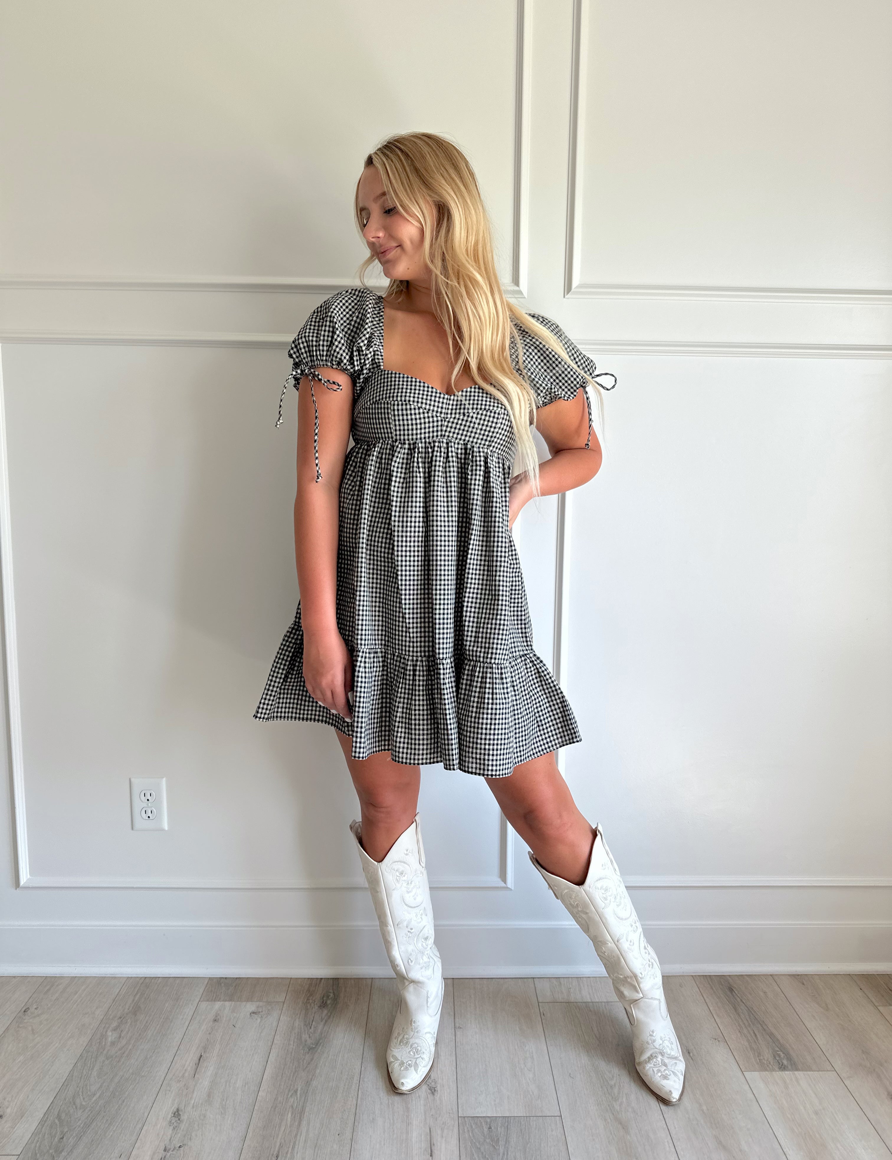 Black and white gingham babydoll mini dress with puff sleeves.