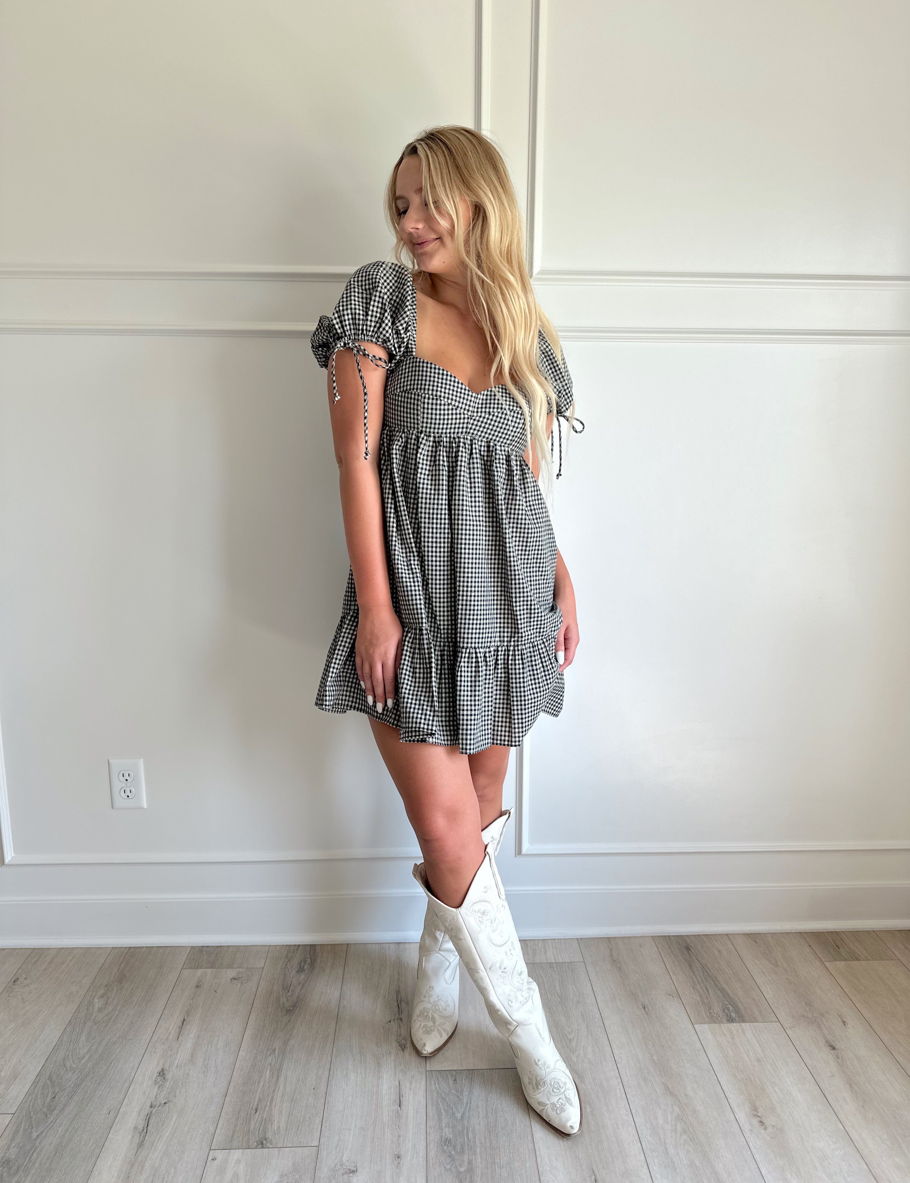 Black and white gingham babydoll mini dress with puff sleeves.