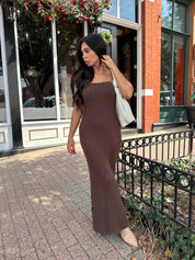 Woman wearing dark brown textured strapless maxi dress. Perfect for fall.