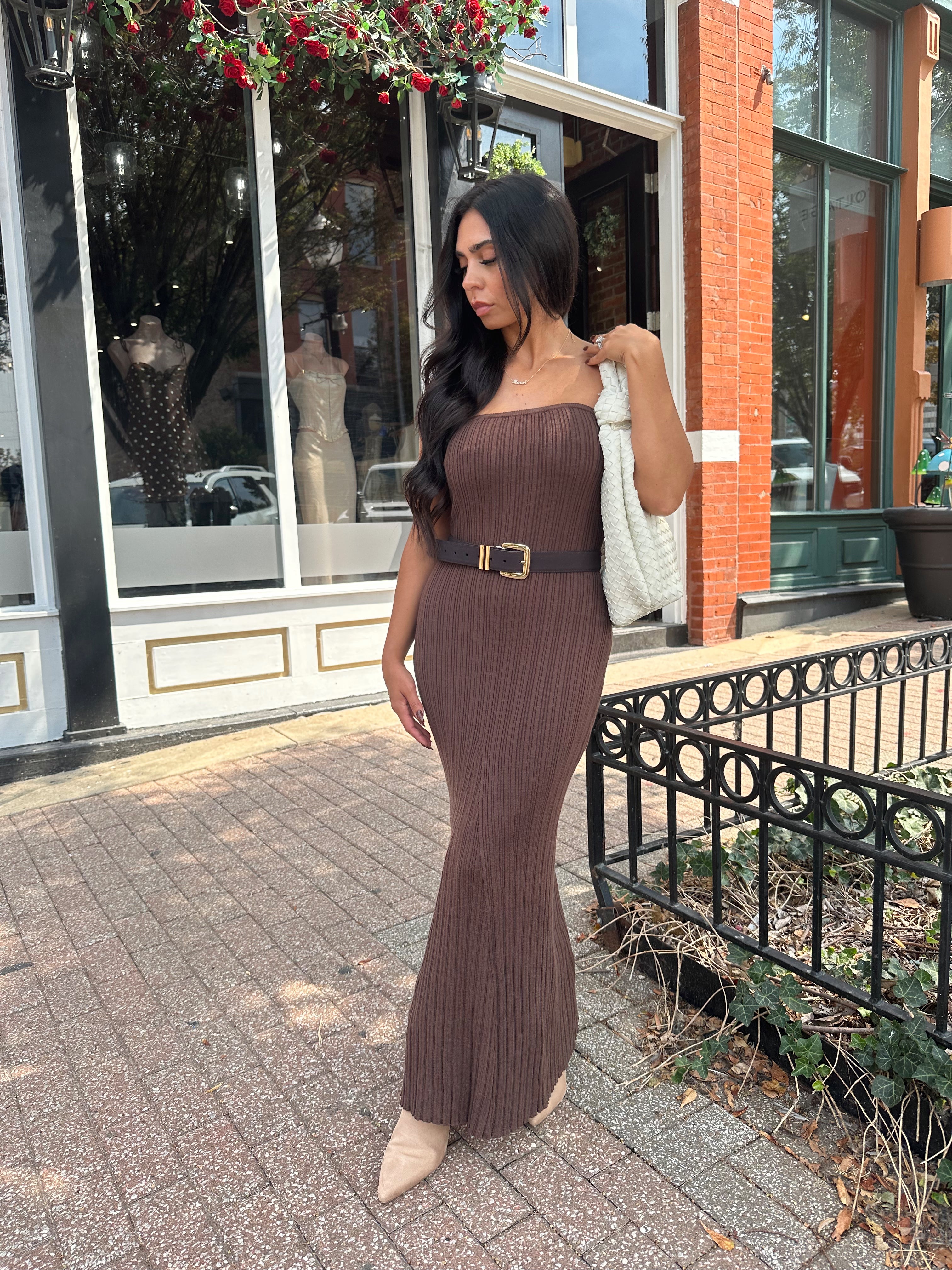 Woman wearing dark brown textured strapless maxi dress. Perfect for fall.