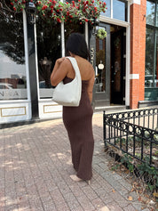 Woman wearing dark brown textured strapless maxi dress. Perfect for fall.