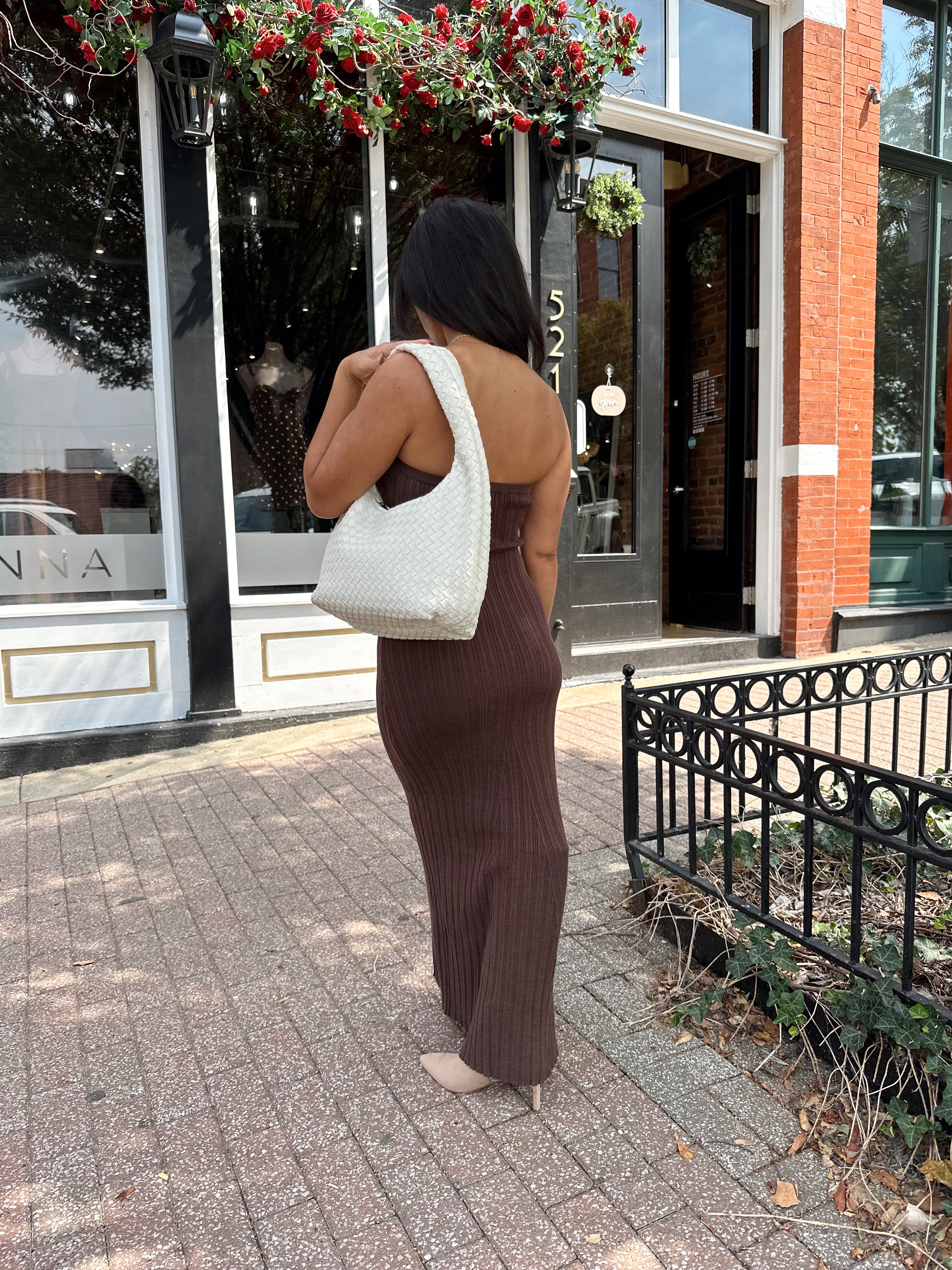 Woman wearing dark brown textured strapless maxi dress. Perfect for fall.