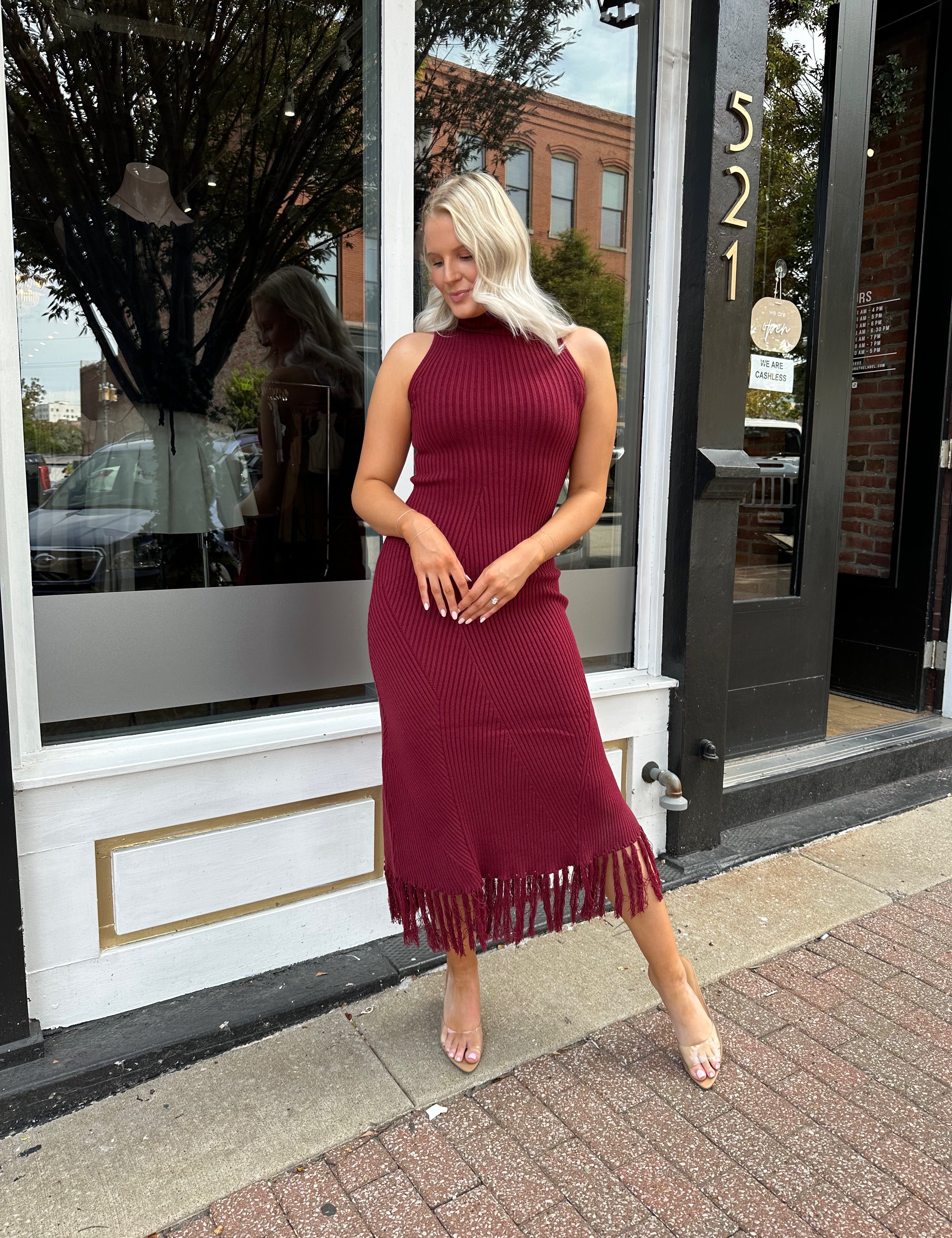 Burgundy ribbed knit maxi dress with turtleneck, body-skimming fit, and fringe hem
