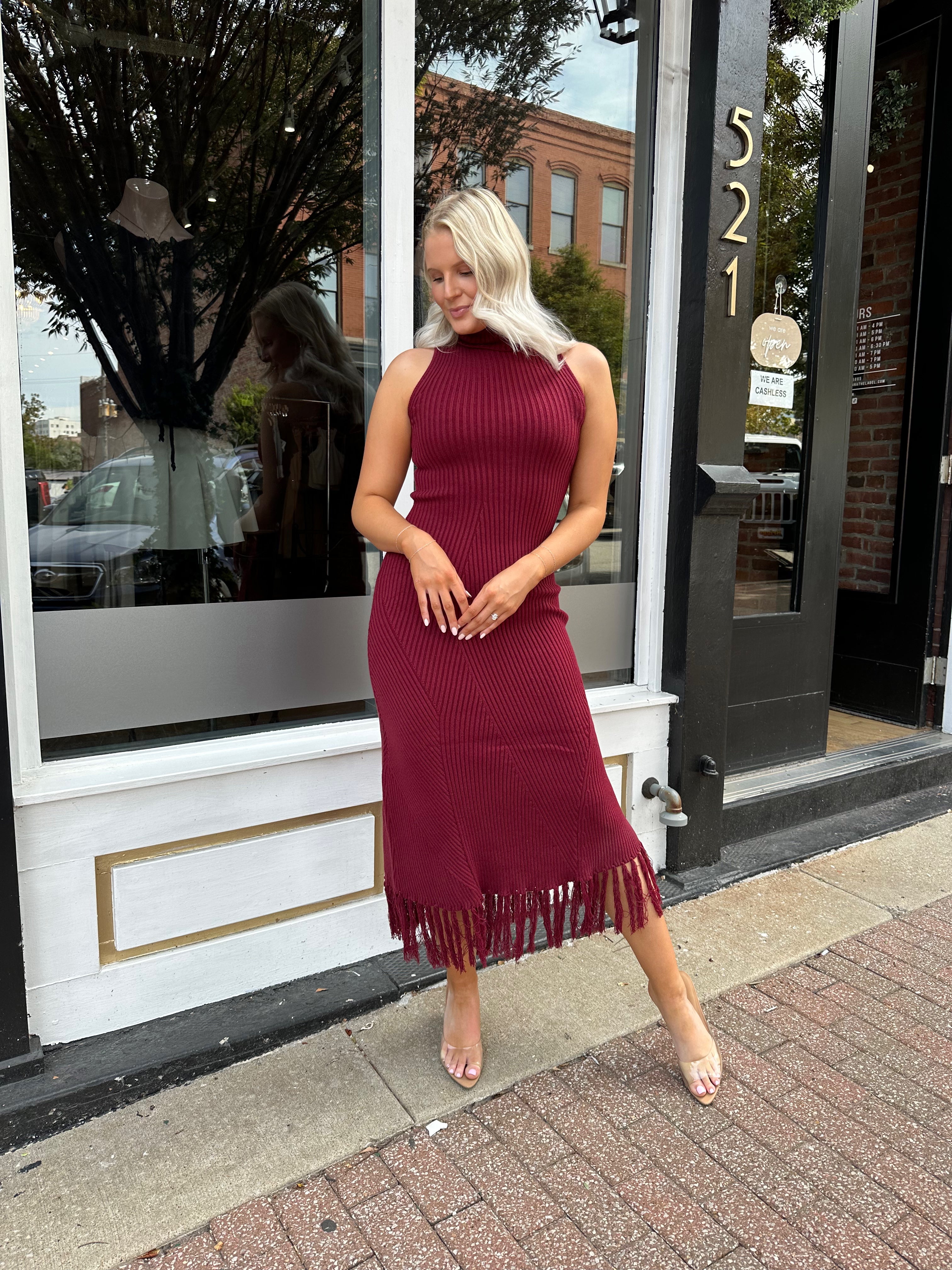 Burgundy ribbed knit maxi dress with turtleneck, body-skimming fit, and fringe hem