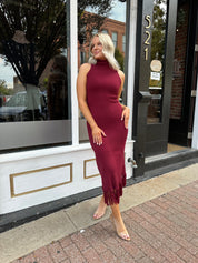 Burgundy ribbed knit maxi dress with turtleneck, body-skimming fit, and fringe hem