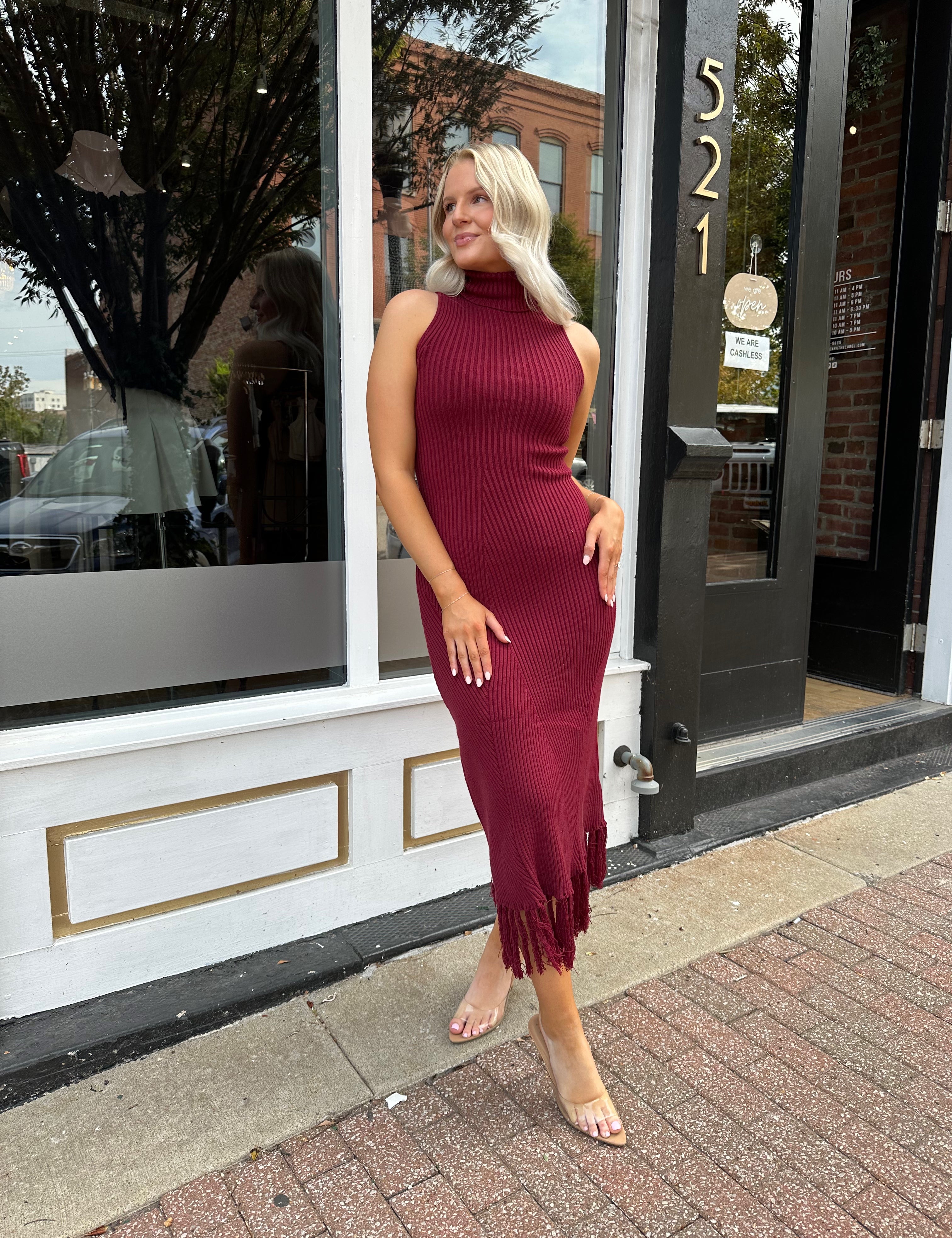 Burgundy ribbed knit maxi dress with turtleneck, body-skimming fit, and fringe hem