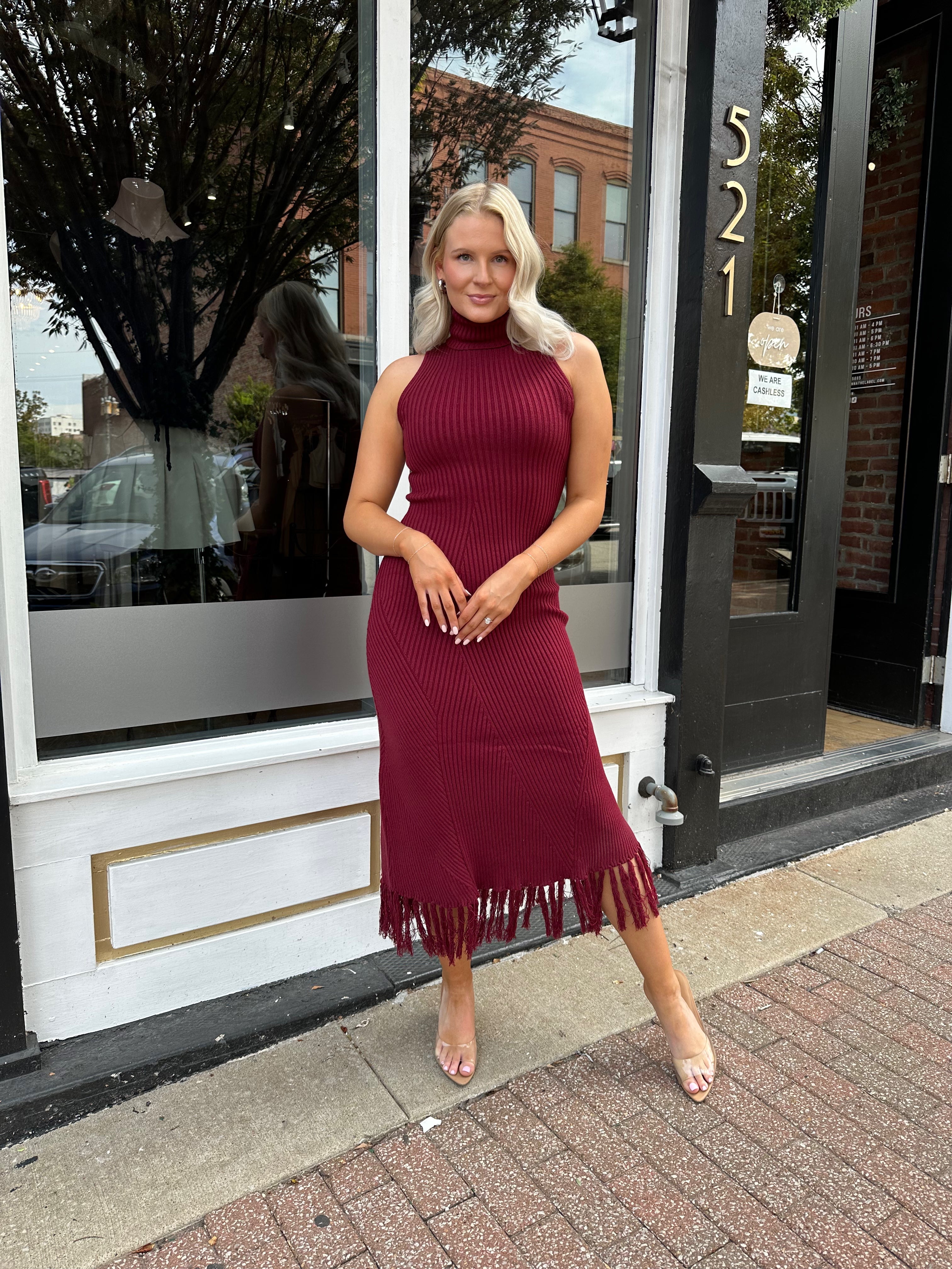 Burgundy ribbed knit maxi dress with turtleneck, body-skimming fit, and fringe hem