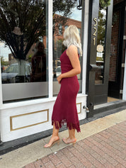 Burgundy ribbed knit maxi dress with turtleneck, body-skimming fit, and fringe hem