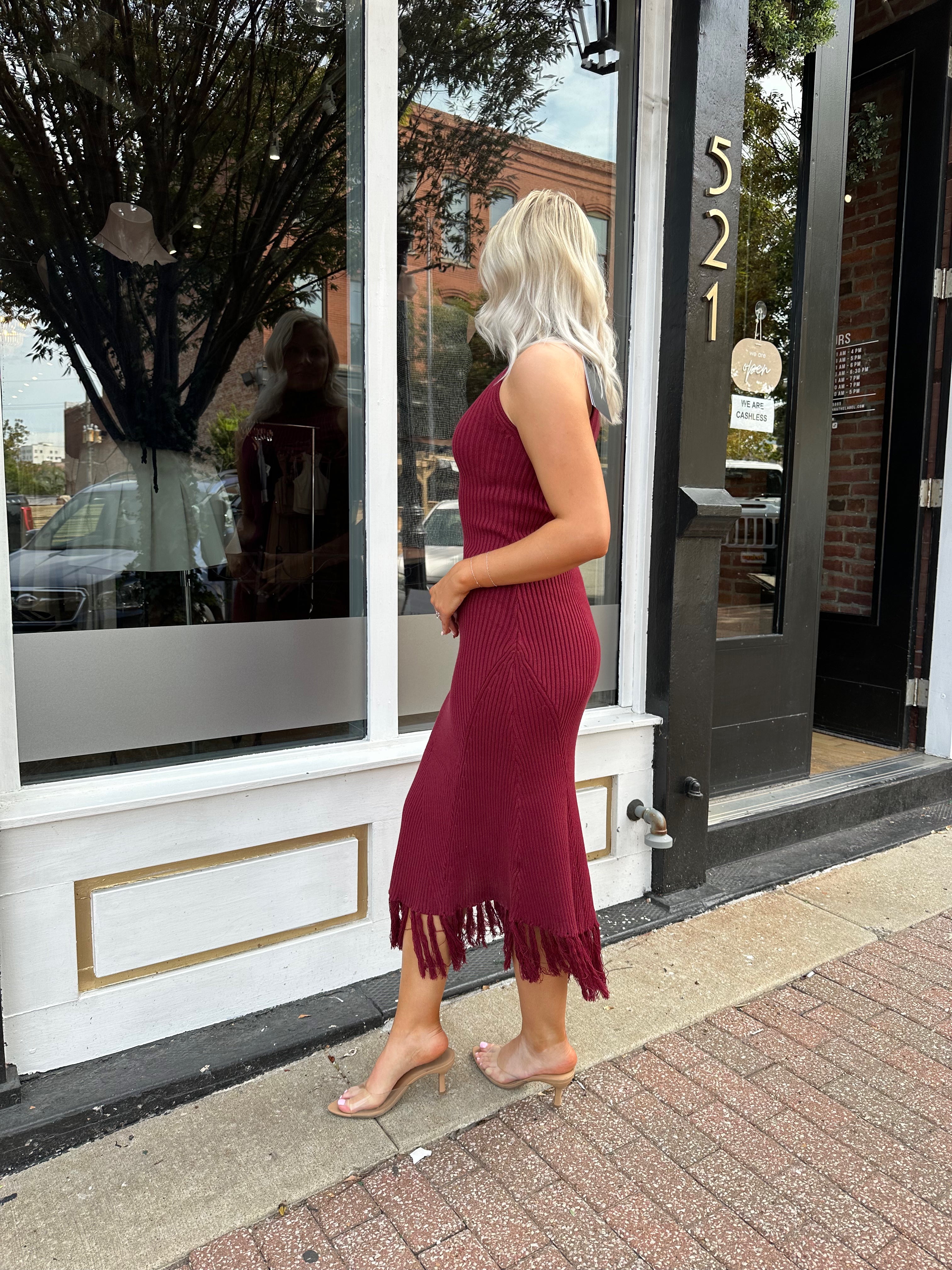 Burgundy ribbed knit maxi dress with turtleneck, body-skimming fit, and fringe hem