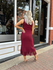 Burgundy ribbed knit maxi dress with turtleneck, body-skimming fit, and fringe hem