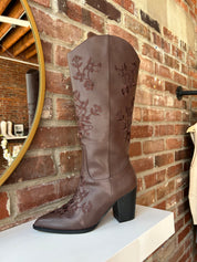Dark brown Western boot with floral embroidery, pointed toe, and stacked block heel