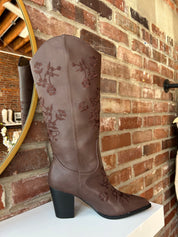 Dark brown Western boot with floral embroidery, pointed toe, and stacked block heel