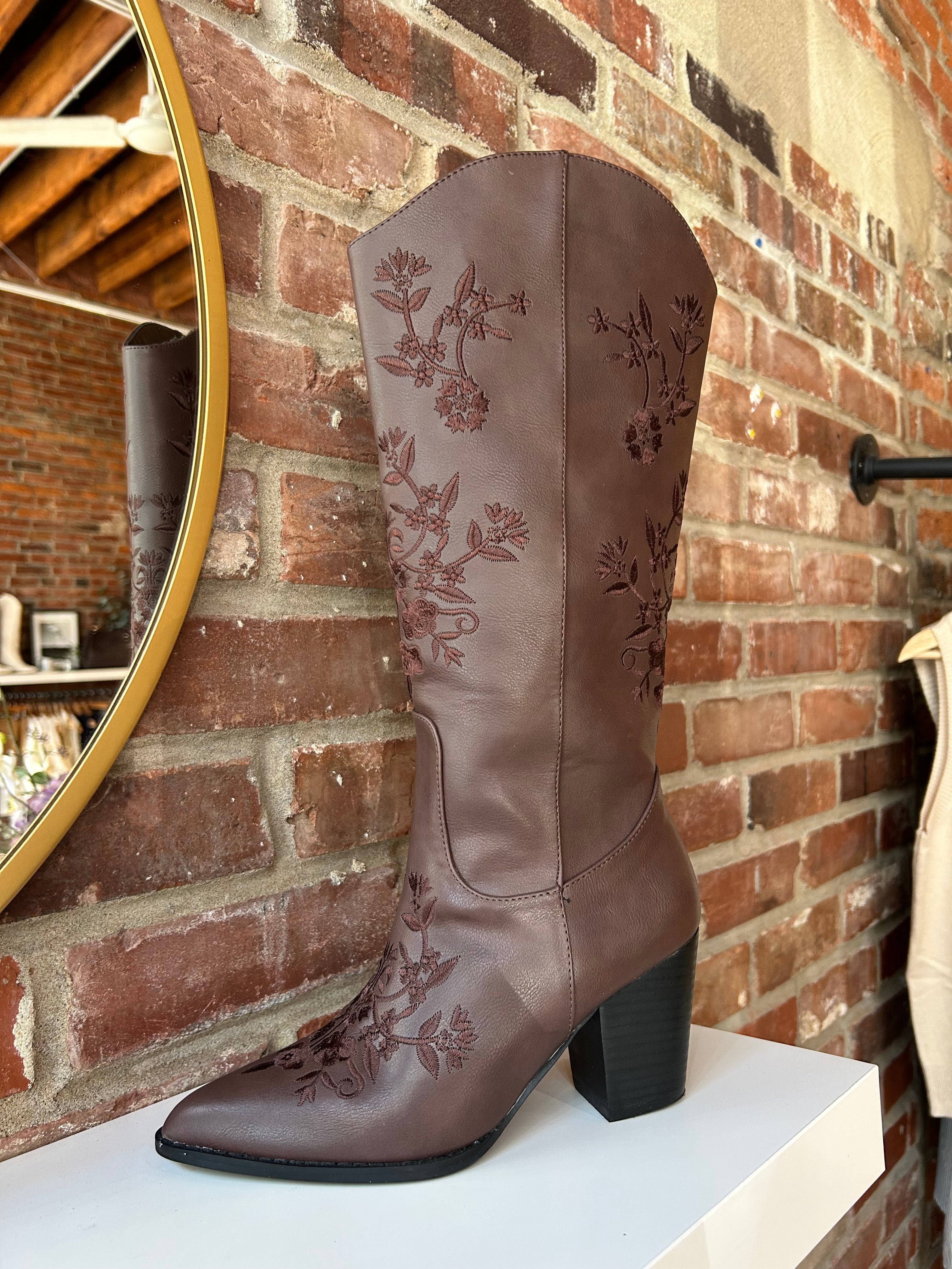 Dark brown Western boot with floral embroidery, pointed toe, and stacked block heel