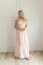 Pink ruched maxi dress with strappy back and tiered flowy skirt