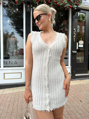 Beige sweater mini dress with fringe trim and front button closure