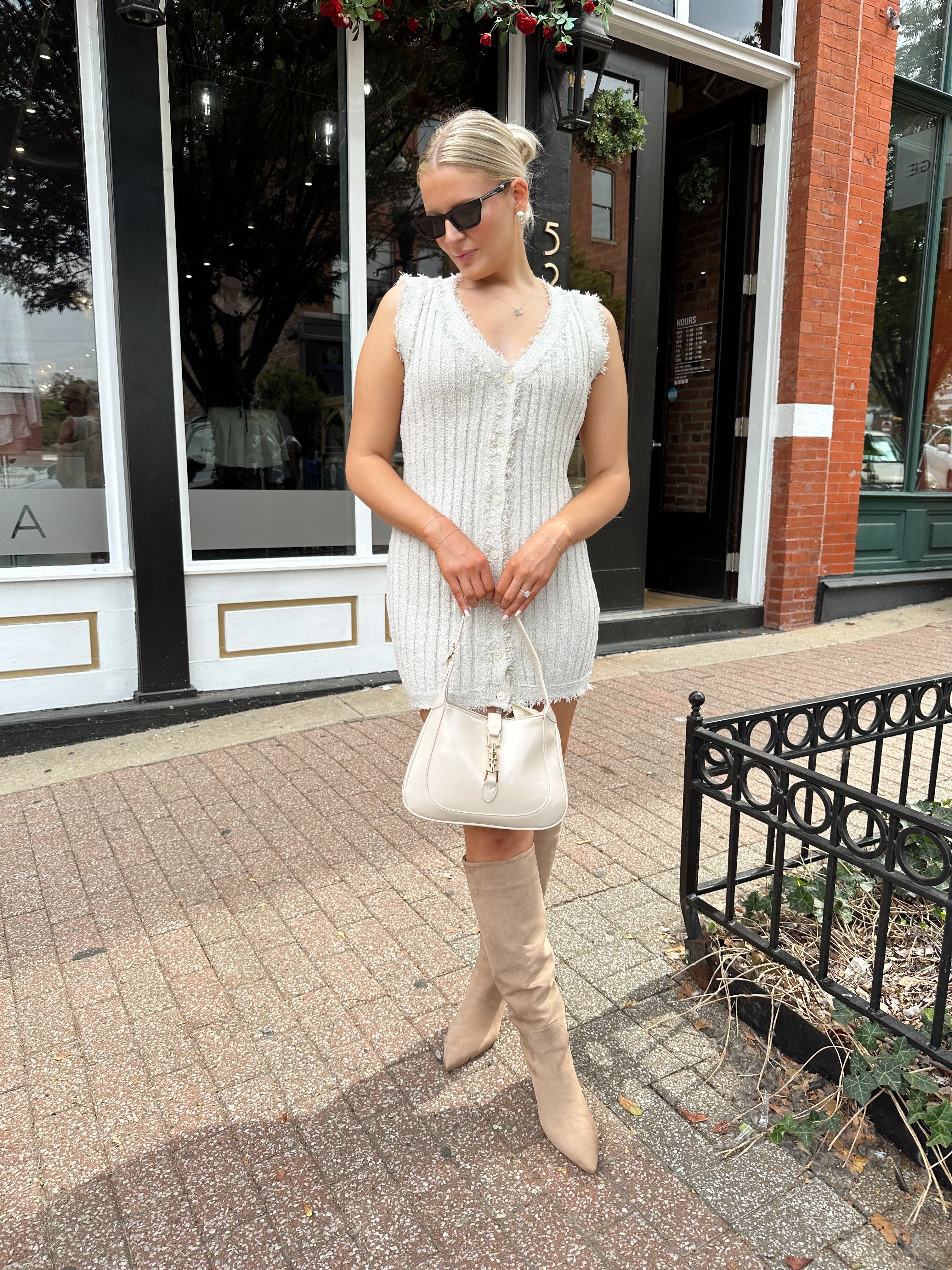 Beige sweater mini dress with fringe trim and front button closure